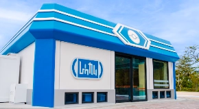 A blue and white building with glass doors

AI-generated content may be incorrect.